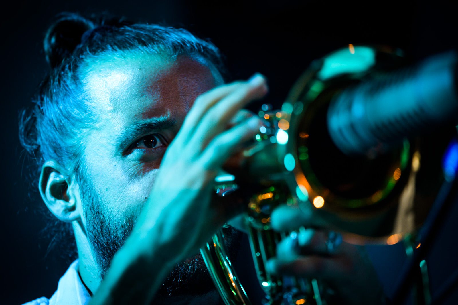 Close up of trumpet player Jay Jennings performing with Snarky Puppy on stage in concert
