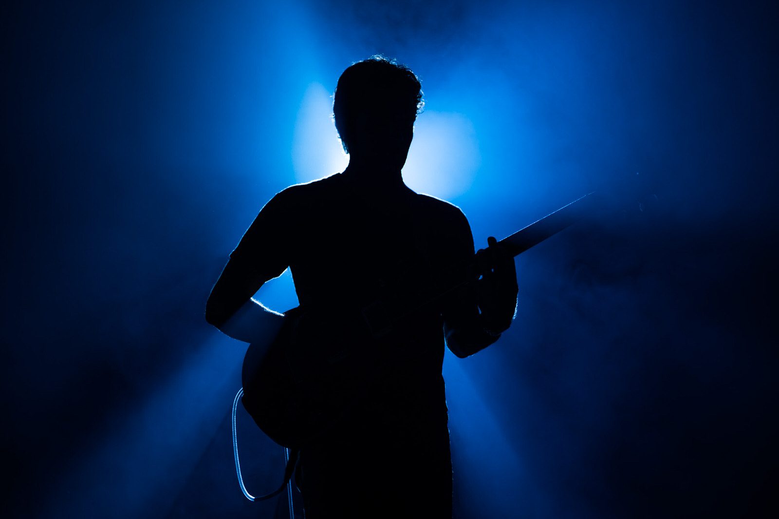 Guitarist Mark Lettieri in silhouette during a Snarky Puppy concert
