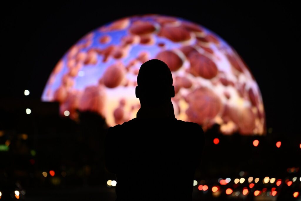 The MSG Sphere in Las Vegas with a person's silhouette