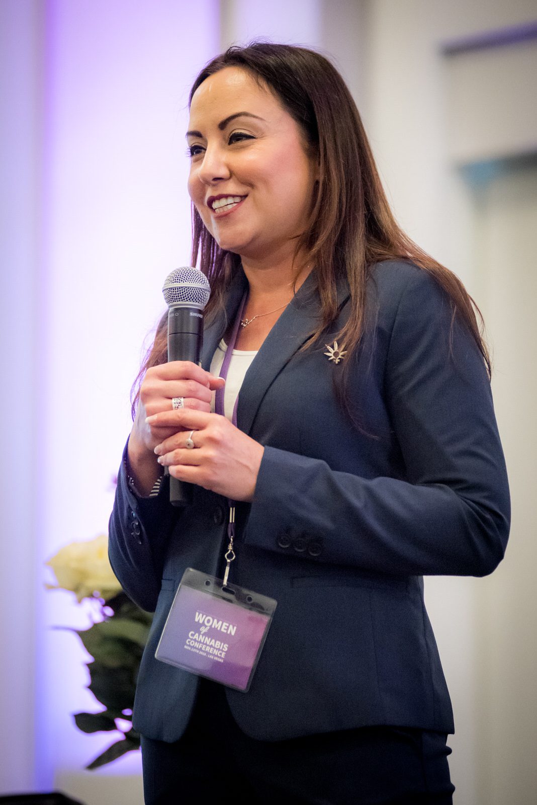 A woman in a navy jacket asks a question at the Women of Cannabis Conference in Las Vegas