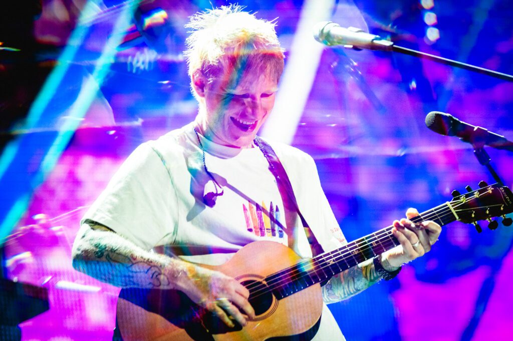 Ed Sheeran performing with guitar at the iHeartRadio Music Festival 2025 in Las Vegas