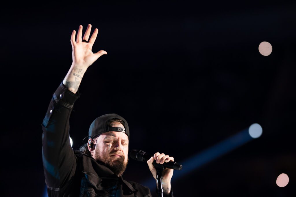 Jelly Roll singing with hand raised at the iHeartRadio Music Festival 2025 in Las Vegas