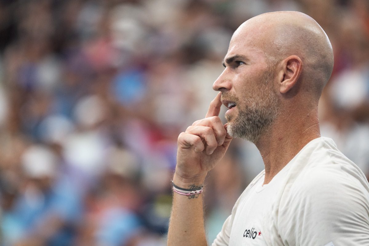 Adrian Mannarino focused courtside at the 2025 US Open, sweat on his face as he concentrates during a match.