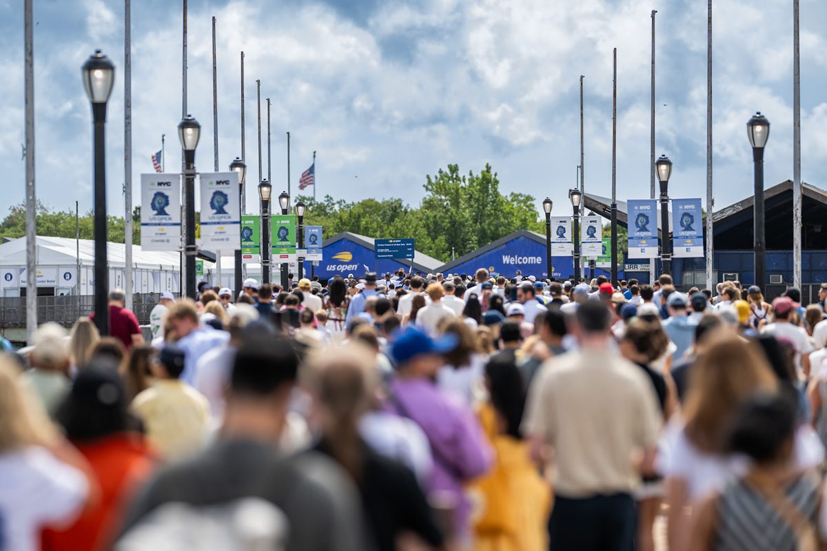 Wide crowd walking into the 2025 US Open entrance at Billie Jean King National Tennis Center in New York.