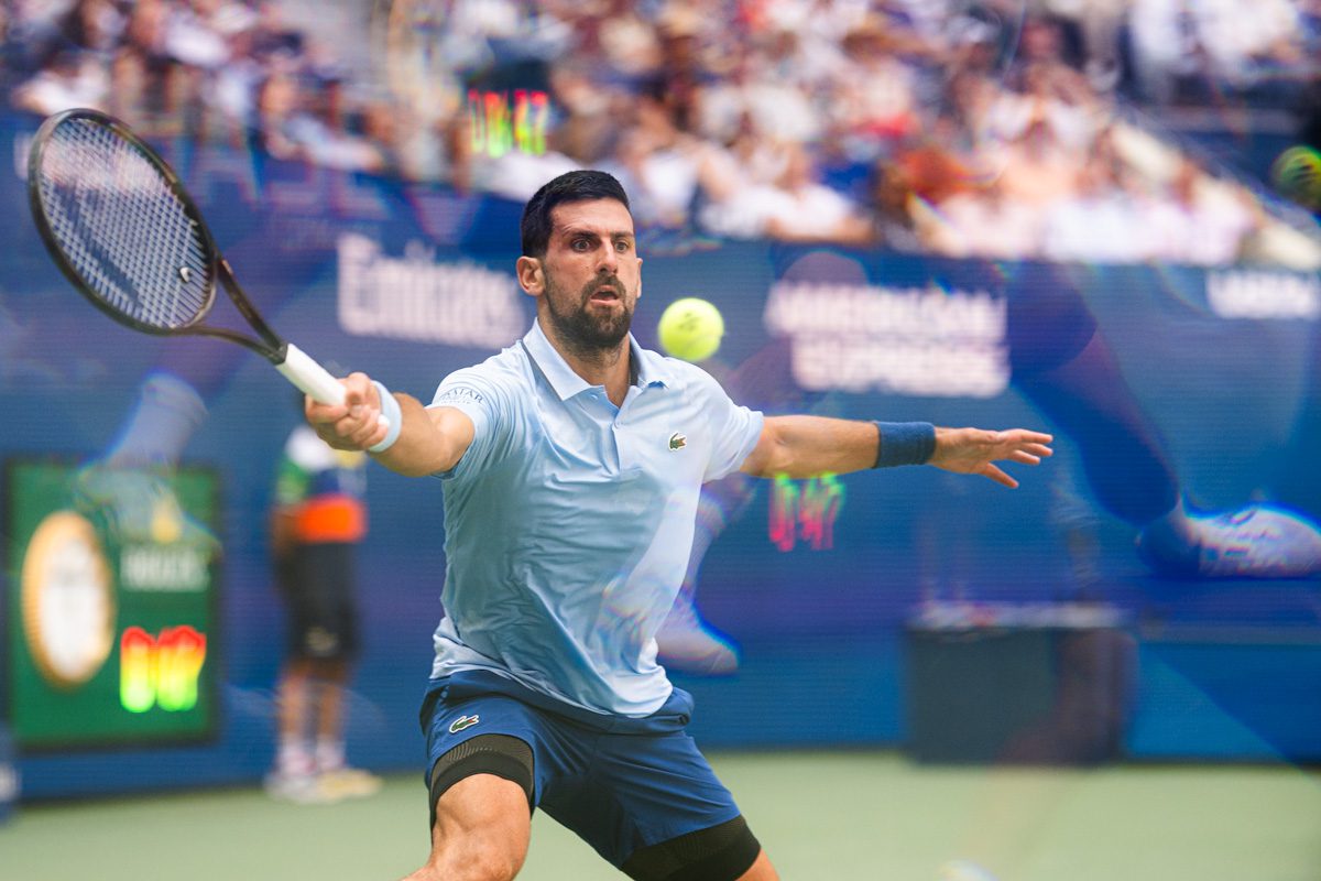 Novak Djokovic swings a forehand return in Ashe Stadium at the 2025 US Open.