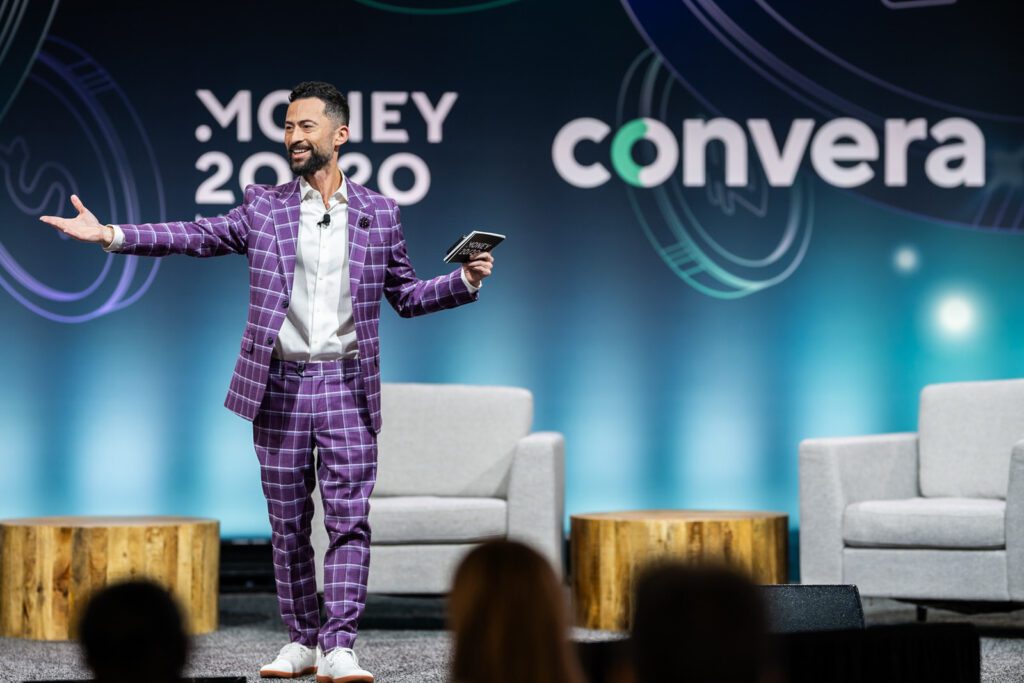 Speaker presenting on stage at the Convera booth during Money20/20 in Las Vegas