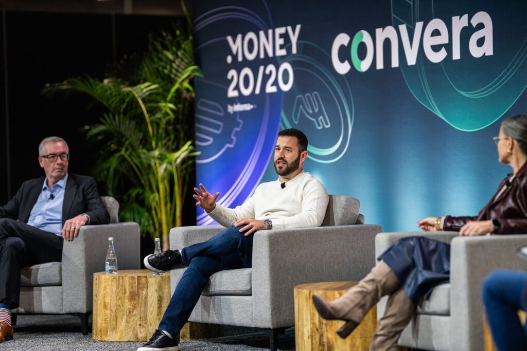 Speaker seated on stage at the Convera booth during Money20/20 in Las Vegas