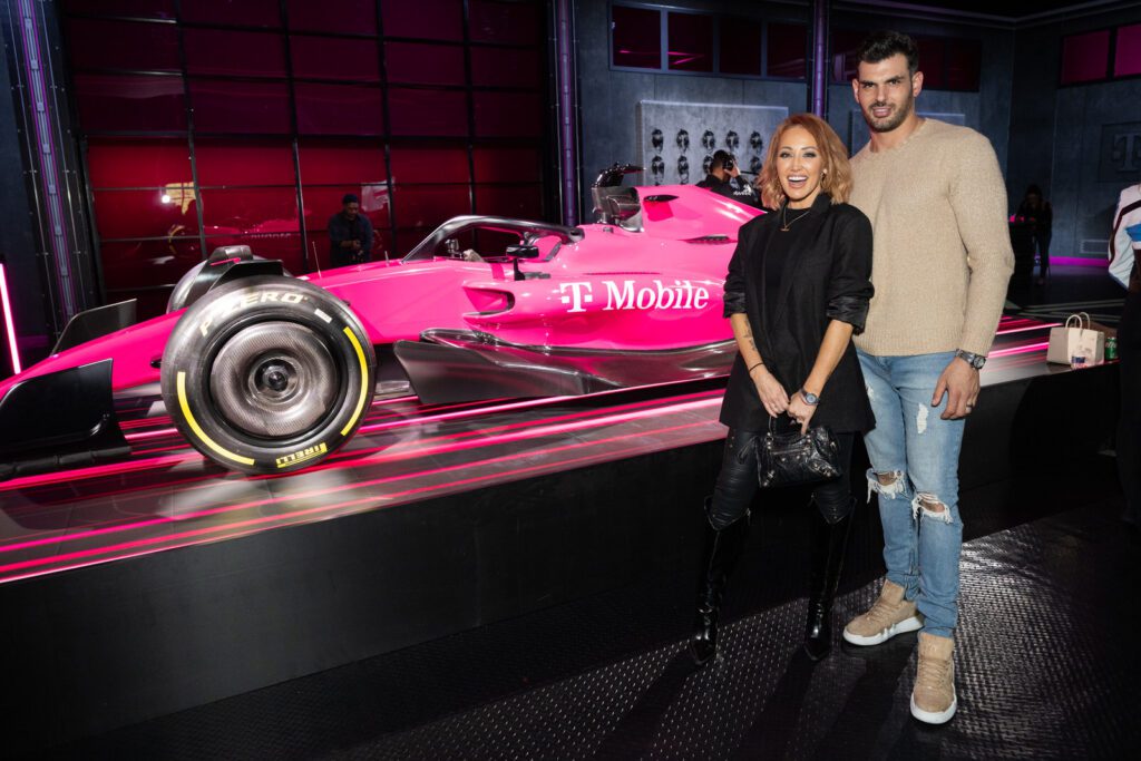 Guests standing beside the pink T-Mobile F1-themed car display at the Switching Made Easy event.