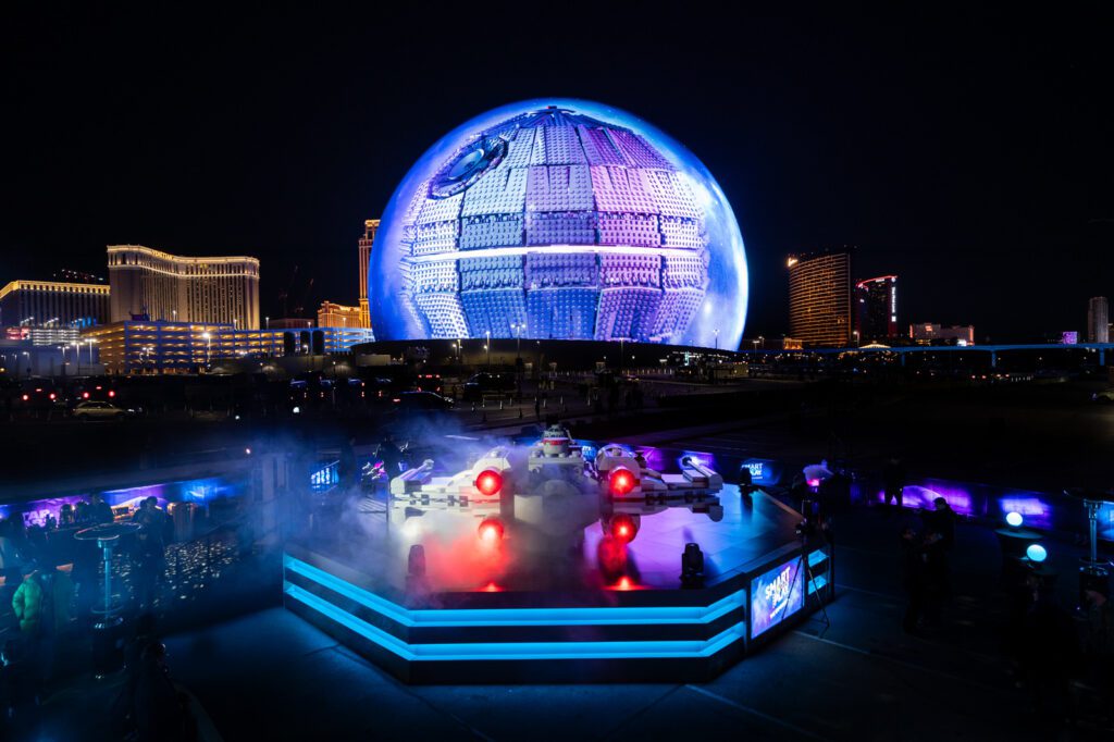 Nighttime wide shot of the LEGO Star Wars SMART Play installation with Sphere Las Vegas illuminated in the background