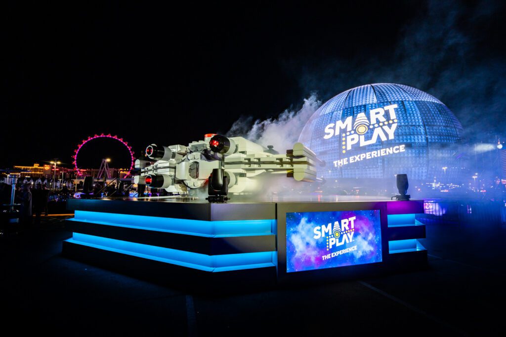 Wide view of the LEGO Star Wars SMART Play installation with smoke effects and illuminated signage at Sphere Las Vegas