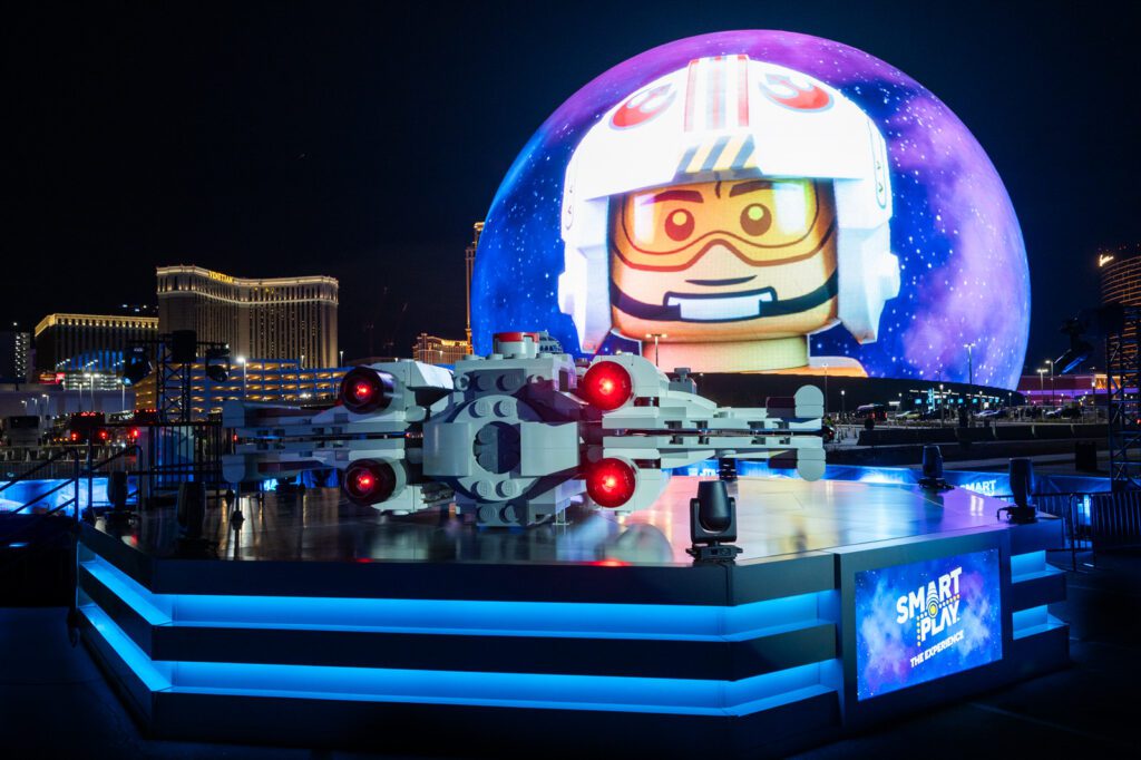 LEGO Star Wars X-wing installation in front of Sphere Las Vegas with Exosphere displaying a LEGO pilot during the SMART Play activation