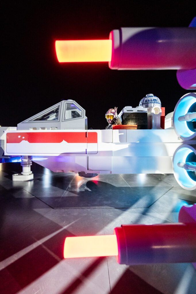 Close-up detail of a LEGO Star Wars X-wing build with illuminated elements during the LEGO SMART Play activation at Sphere Las Vegas