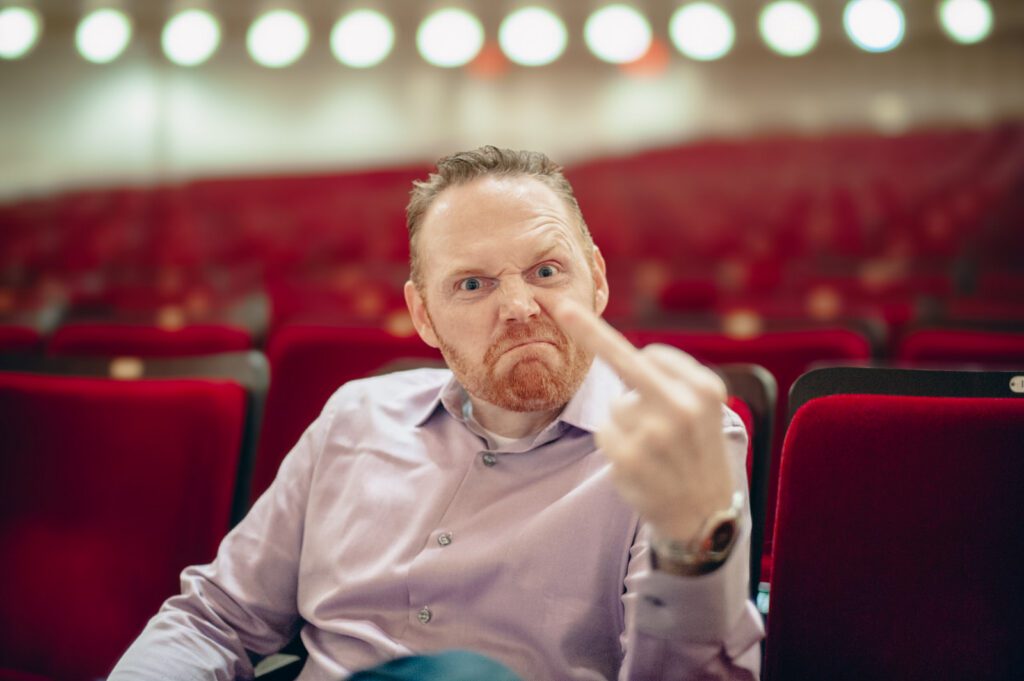 Portrait of Bill Burr seated inside Carnegie Hall before performance