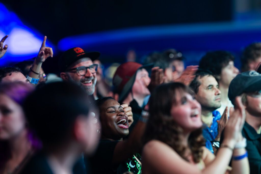 Crowd of joyful fans laughing and cheering during a performance at Ground Up Music Festival 2026 in Miami